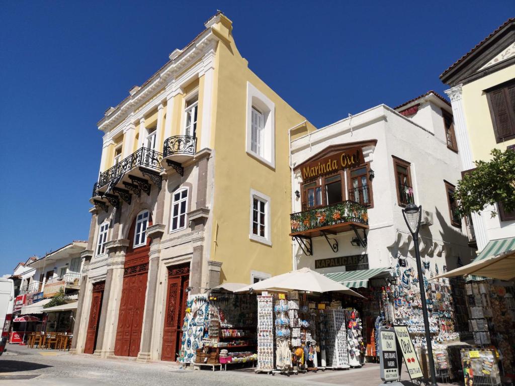 a building on a street with a store at Marinda Otel in Cesme