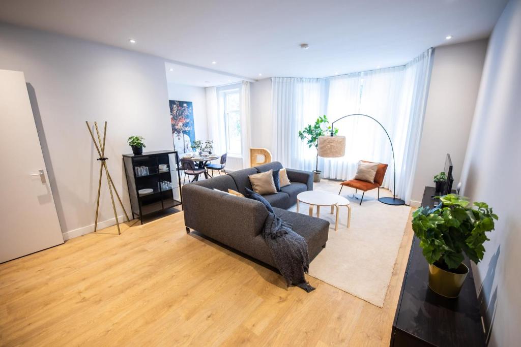 a living room with a couch and a table at Alphabet Apartments - Villapark 2 in Rotterdam