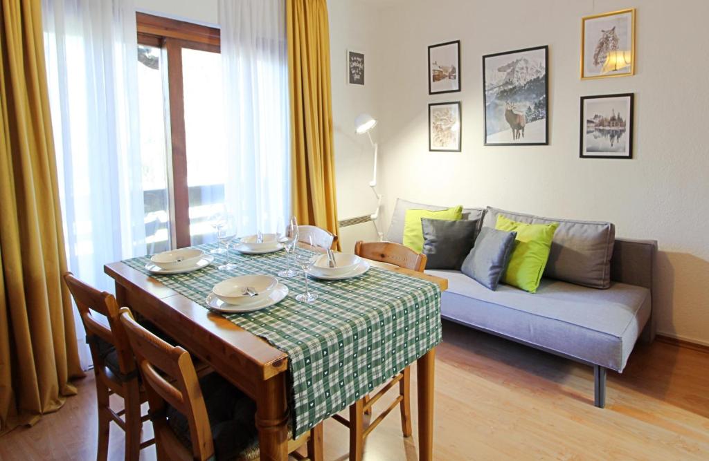 a living room with a table and a couch at Ski-to-door apartment Waldrand in Bad Kleinkirchheim