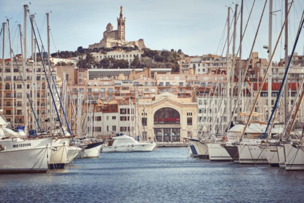a bunch of boats are docked in a harbor at Le Passe-Port pour Marseille in Marseille