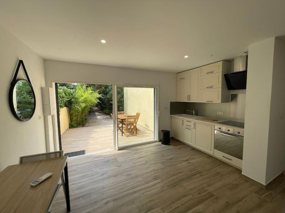 a kitchen with a table and a dining room at Grand studio neuf à Carry le Rouet in Carry-le-Rouet