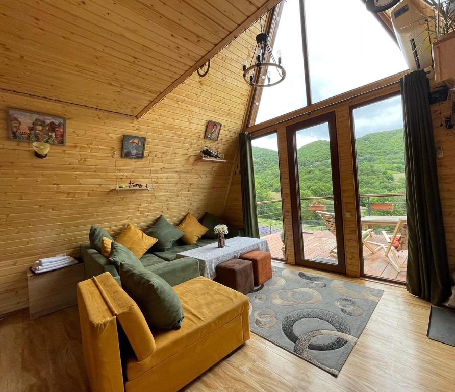 a living room with a couch and a table at Cozy cabin in Tbilisi City