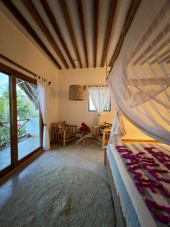 Postel nebo postele na pokoji v ubytování Boutique Villa Unaweza