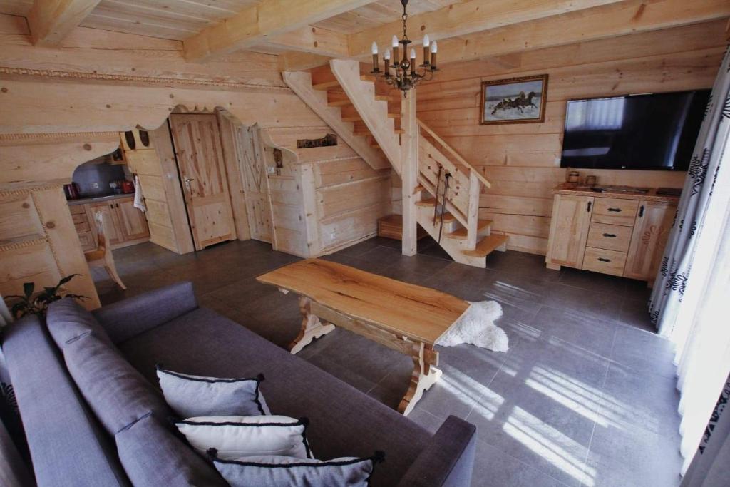 a living room with a couch and a table at BIAŁY PUCH in Zakopane