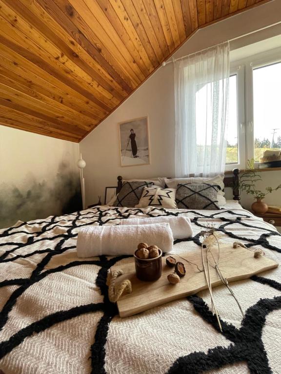 a bedroom with a large bed with a wooden ceiling at Na stoku in Korbielów