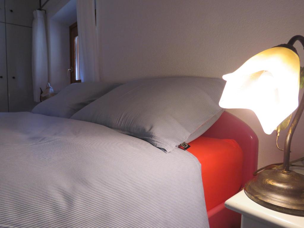 a bedroom with a bed and a lamp on a table at Baita Li Selucia in Livigno