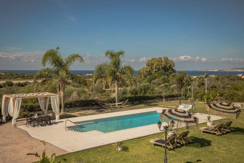 a swimming pool with a view of the ocean at Queen Bee Residence in Minia