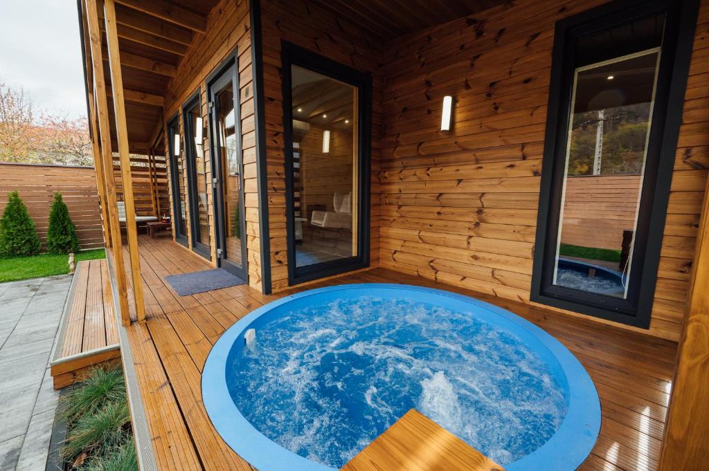a hot tub on the deck of a house at Telegdy Homes in Praid