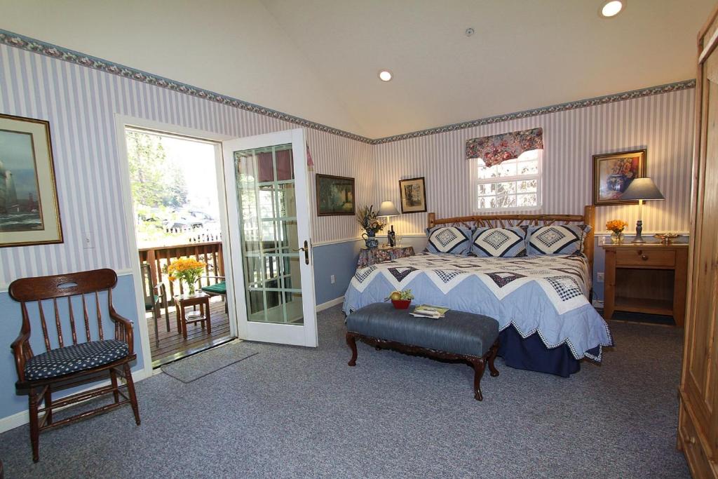 a bedroom with a bed and a desk and a chair at McCaffrey House Bed and Breakfast Inn in Twain Harte