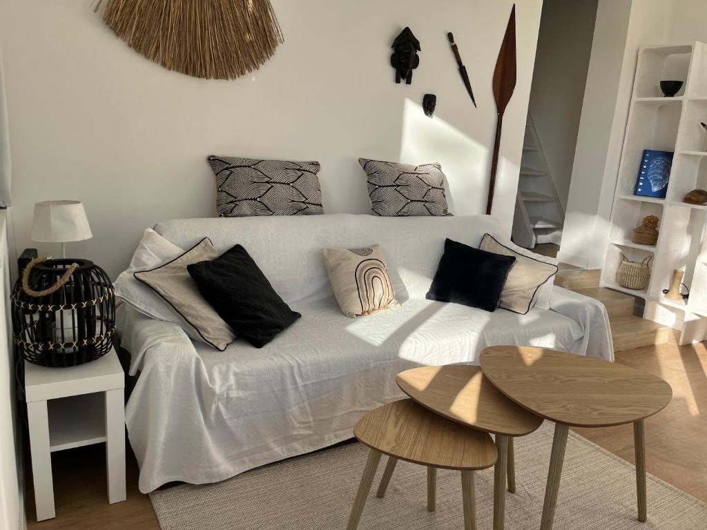 a white bed with pillows on it in a room at Cabanon contemporain - Côte bleue - Calanque de la Redonne in Ensuès-la-Redonne