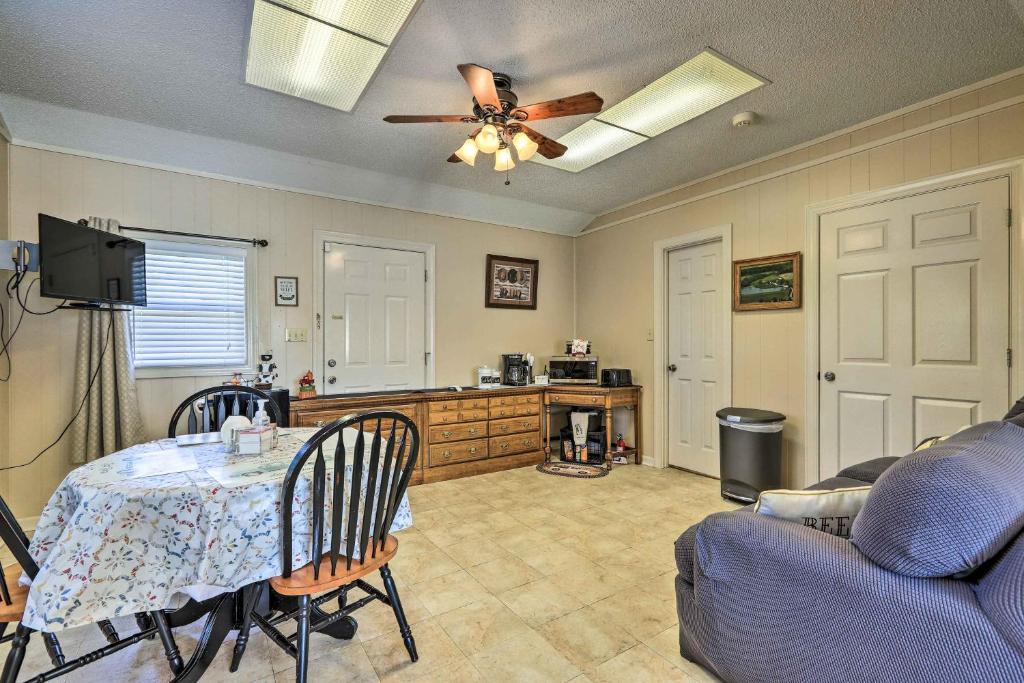 a living room with a table and a ceiling fan at Cozy Hawkinsville Studio on Operating Farm! in Hawkinsville