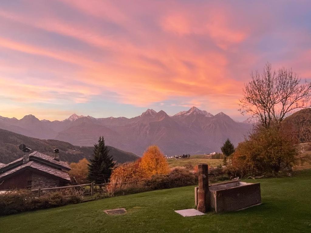 a sunset over a mountain range with a cemetery at STOP & STARE STARS in Lignan