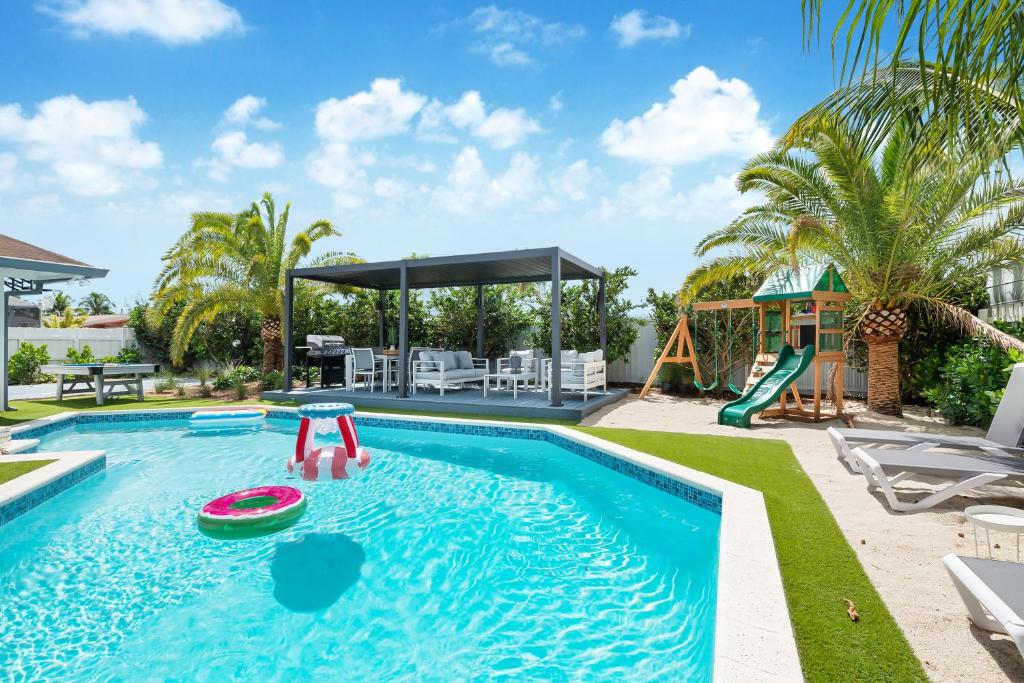 a swimming pool with a slide and a playground at 5BR Oasis Heated Pool, Games L06 in Miami