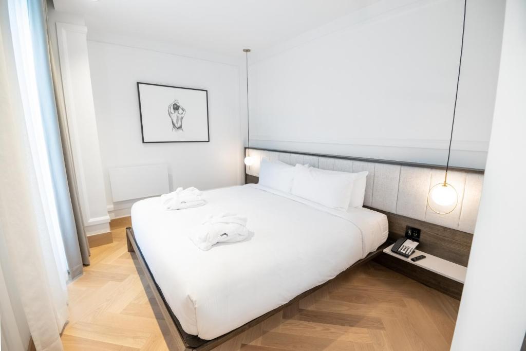 Postel nebo postele na pokoji v ubytování Hôtel Boutique Ophelia