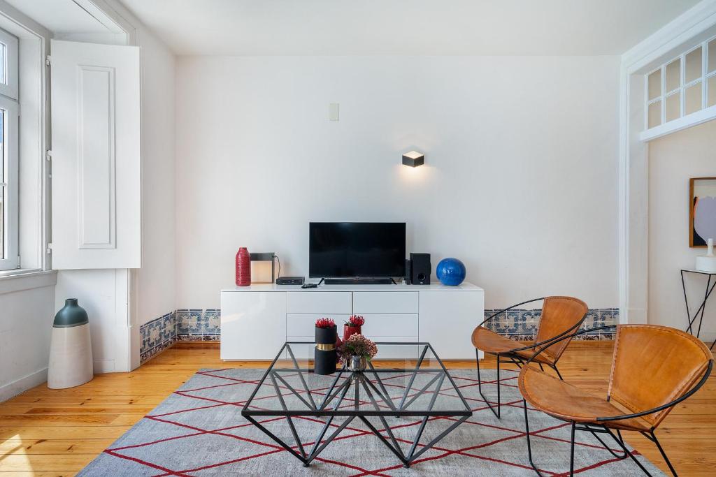 a living room with two chairs and a table at WHome Alecrim 43 Top Location perfect to explore Lisbon in Lisbon
