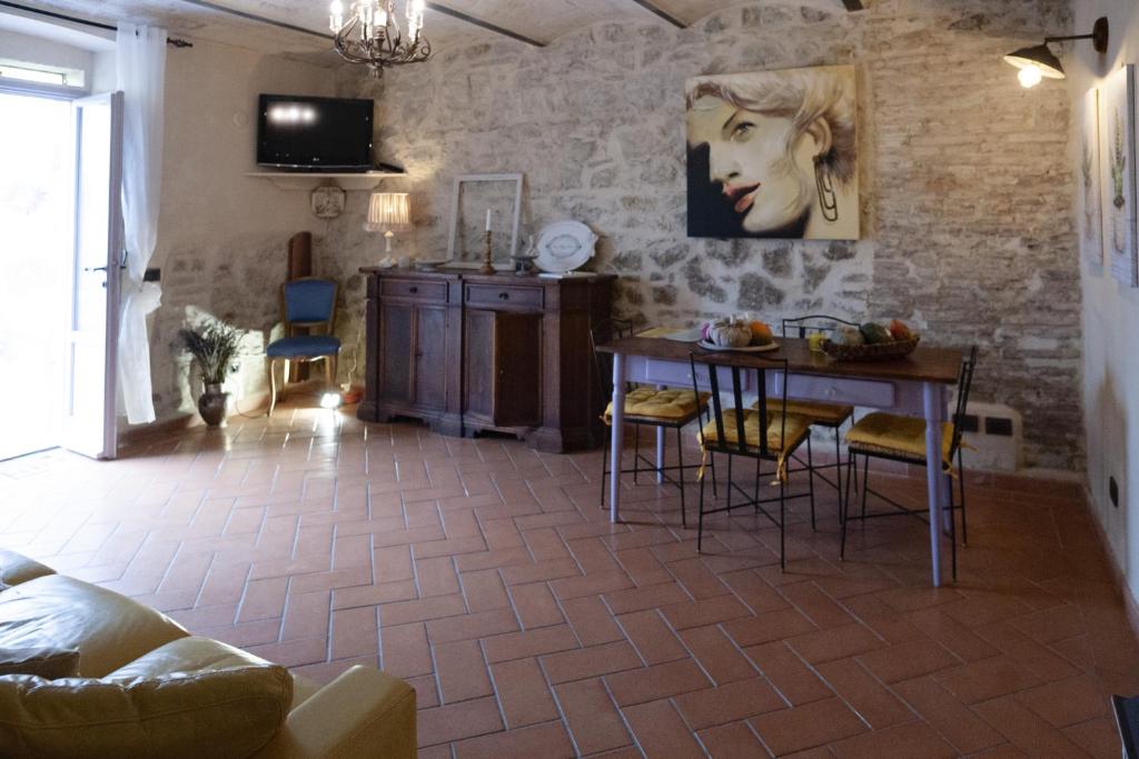 a living room with a table and chairs in a room at Chianti-Home Palagione in Strada
