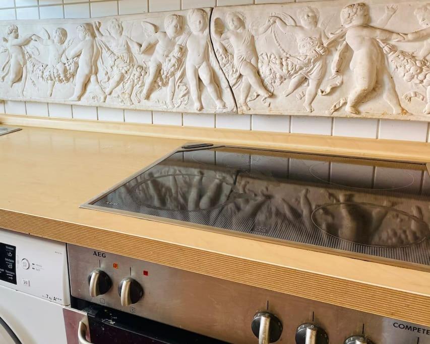 a counter top with a relief above a microwave at Helle, grosse, zentrale Wohnung mit Balkon in Munich