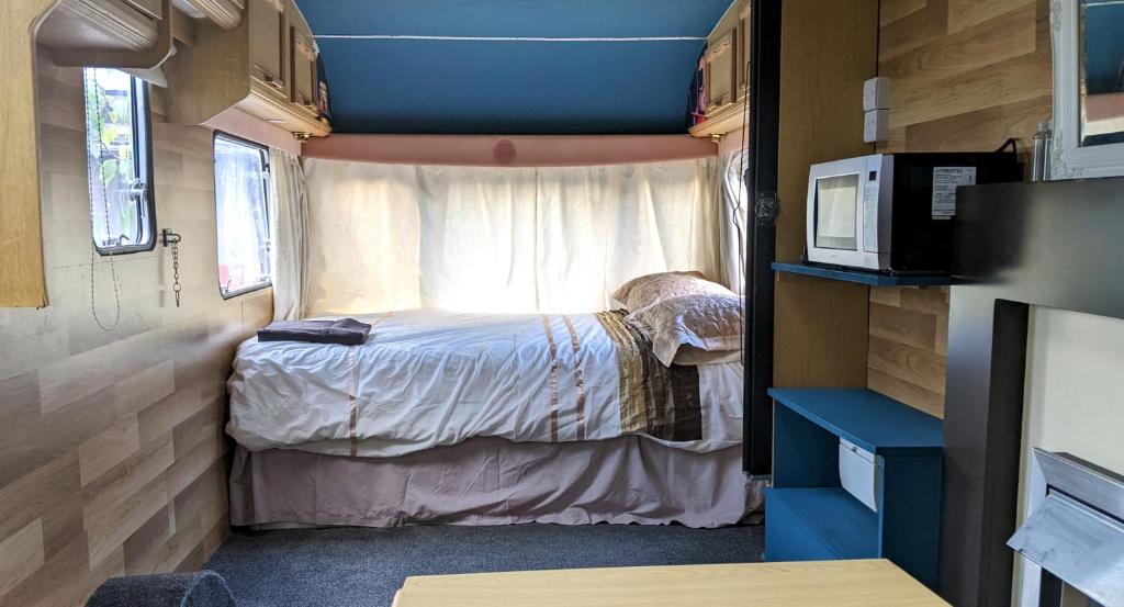 a small room with a bed in a trailer at Cara Noir in Inverness