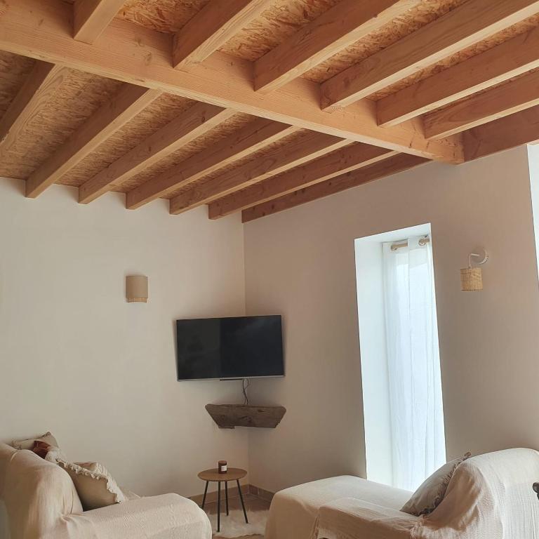 TV a/nebo společenská místnost v ubytování Cottage chaleureux dans un Domaine d'exception