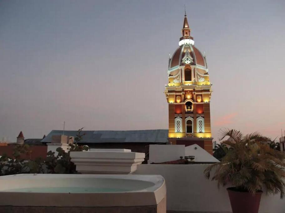 a building with a clock tower with lights on it at Hermoso Apto en el corazón de la ciudad amurallada in Cartagena de Indias