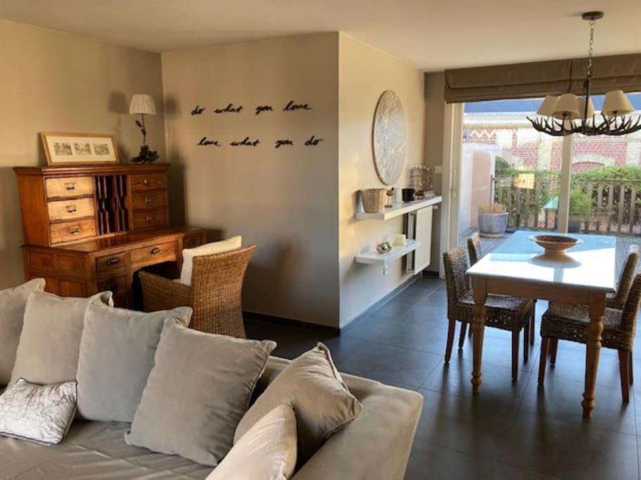 - un salon avec un canapé et une salle à manger dans l'établissement Agréable et Spacieuse maison centre ville Saint-Omer, à Saint-Omer