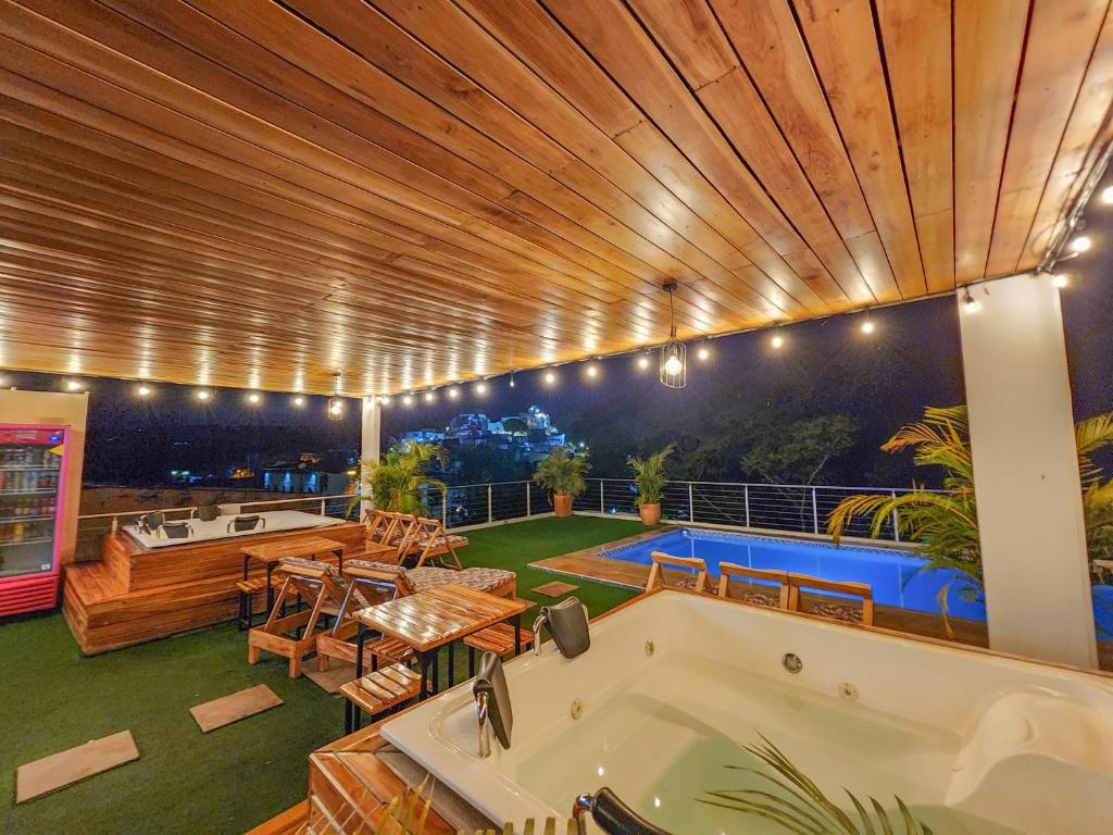 a large room with a bath tub and a patio at MIRADORES DEL PARAISO in Doradal