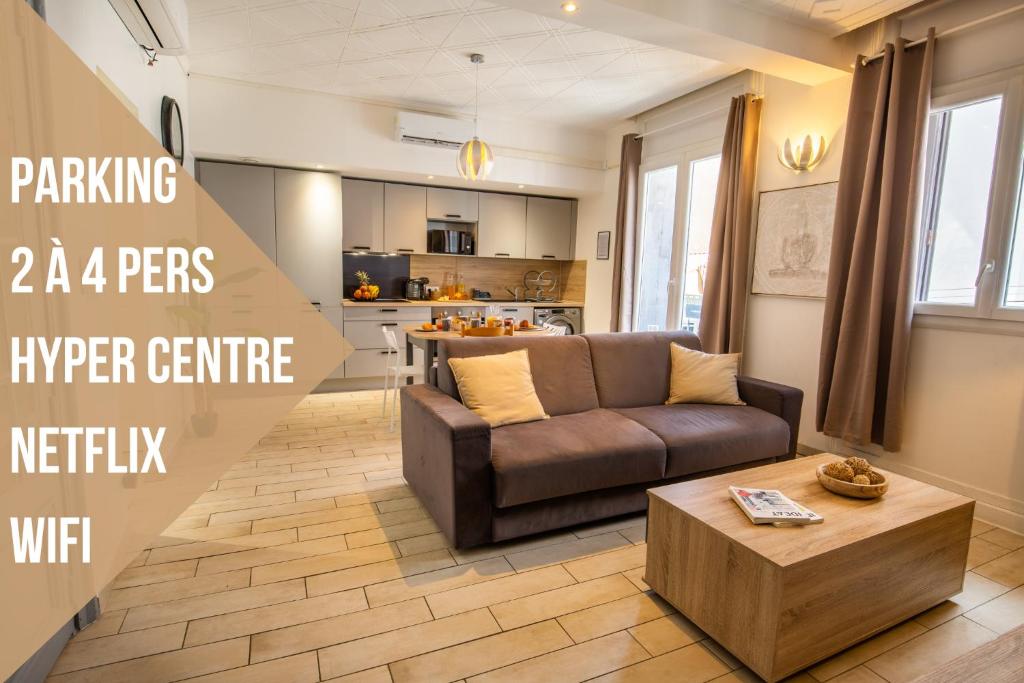 a living room with a couch and a coffee table at Centre Historique -FREE Parking-WIFI-NETFLIX-ZEN&COSY-SLEEPNTRIPBEZIERS in Béziers