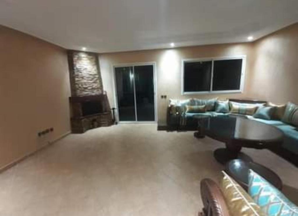 a large living room with a couch and a table at Résidence diamant vert 7 sidi Bouzid in Sidi Bouzid