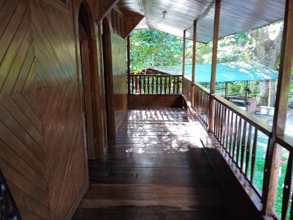 an inside view of a wooden walkway in a house at casa en el parque tayrona in Santa Marta