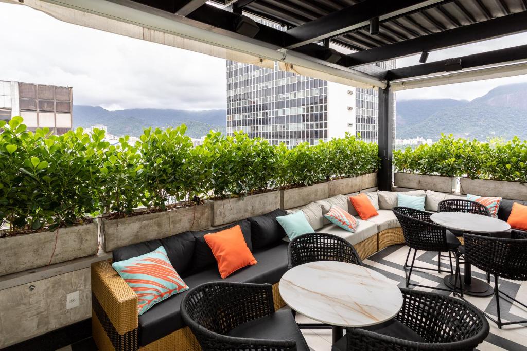 a patio with tables and chairs on a building at Mar Ipanema Hotel in Rio de Janeiro