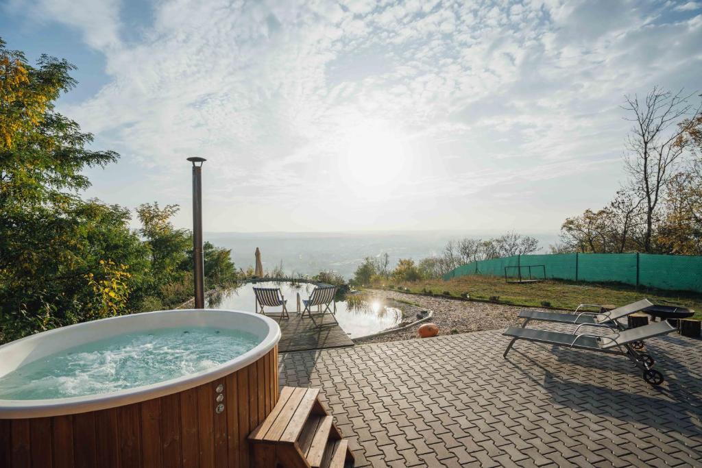 a jacuzzi tub on a patio with a view at Maringotka Olívie v Ivančicích in Ivančice