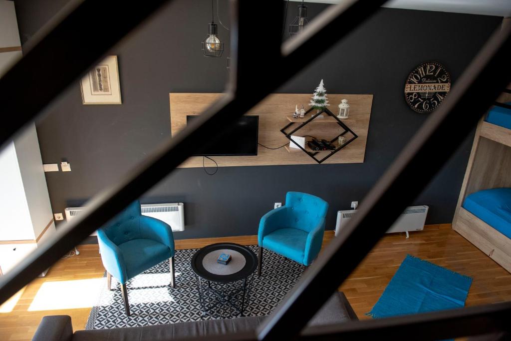 an overhead view of a living room with blue chairs at Apartman Andjela in Kopaonik