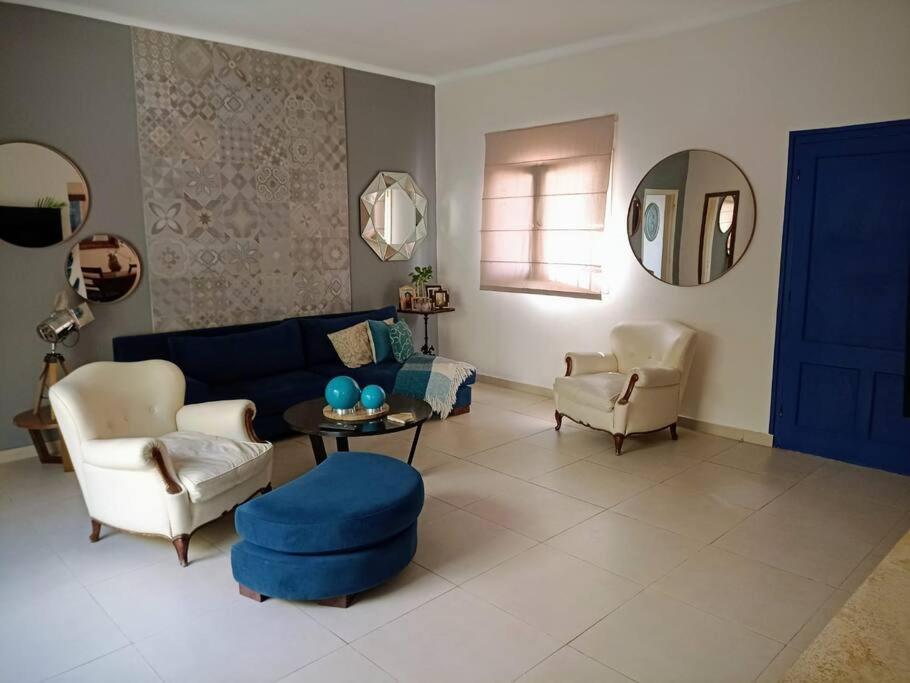 a living room with a blue couch and chairs at La Casa de la Puerta Azul in Mendoza