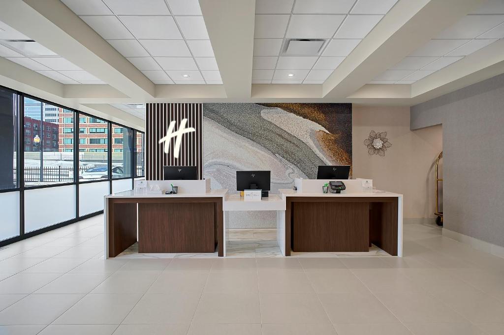 an office with two desks and a painting on the wall at Holiday Inn Hotel & Suites Chicago - Downtown, an IHG Hotel in Chicago