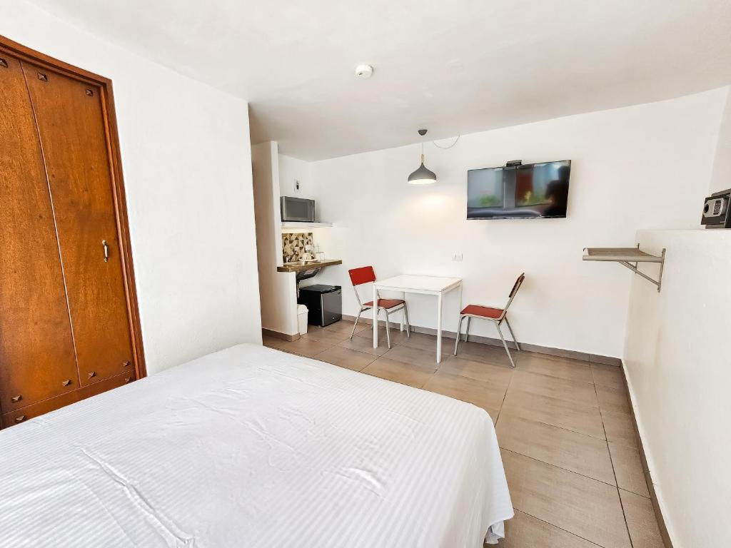 Postel nebo postele na pokoji v ubytování Niebla Suites