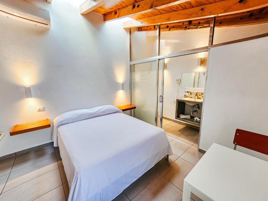 Postel nebo postele na pokoji v ubytování Niebla Suites