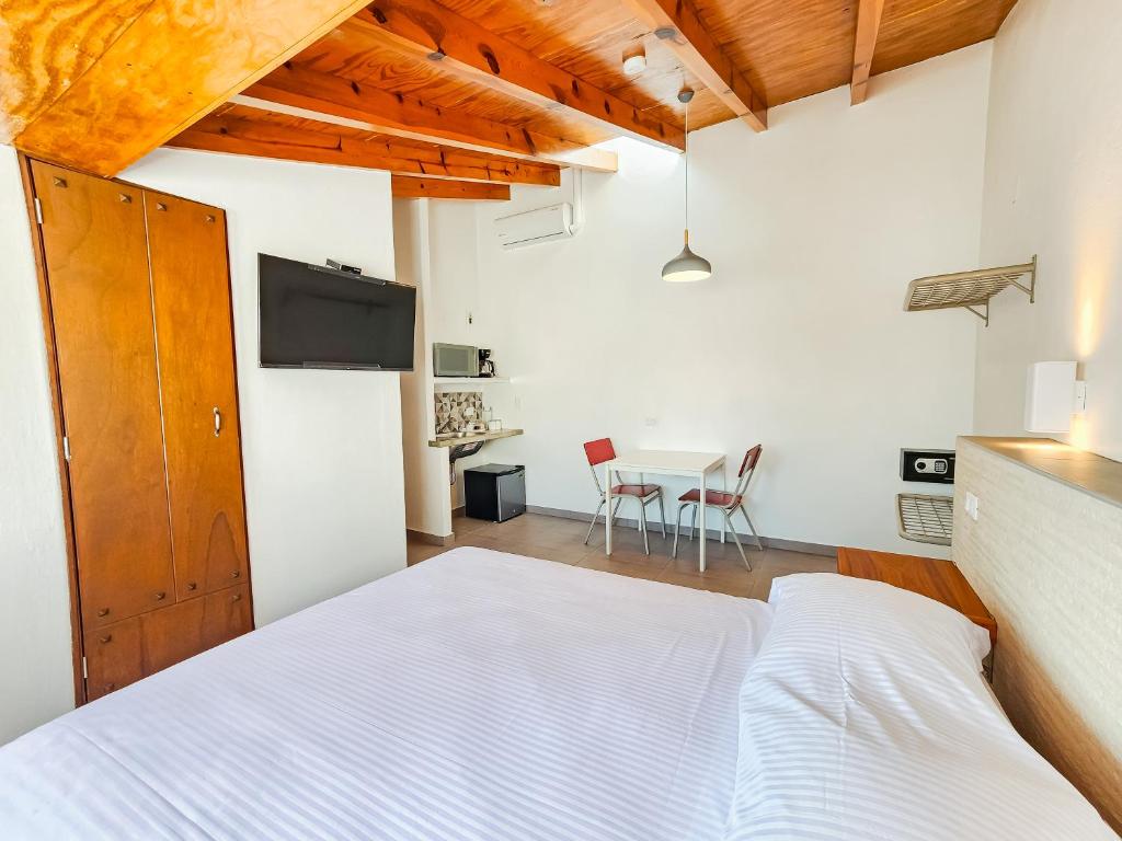 Postel nebo postele na pokoji v ubytování Niebla Suites