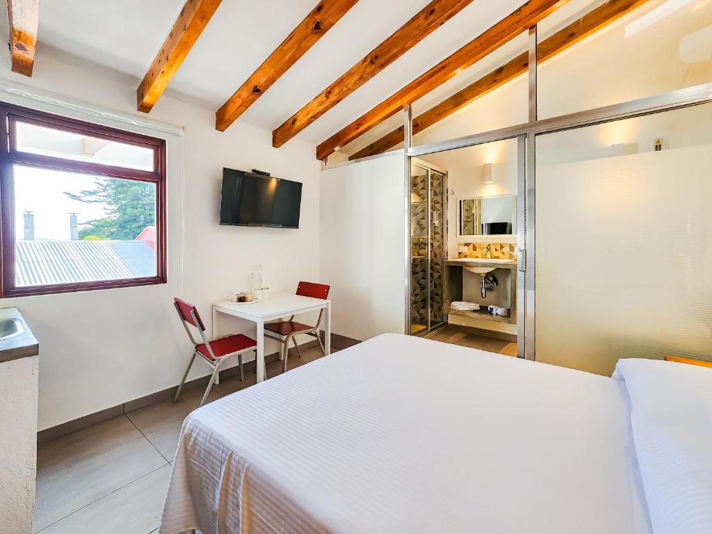 TV a/nebo společenská místnost v ubytování Niebla Suites