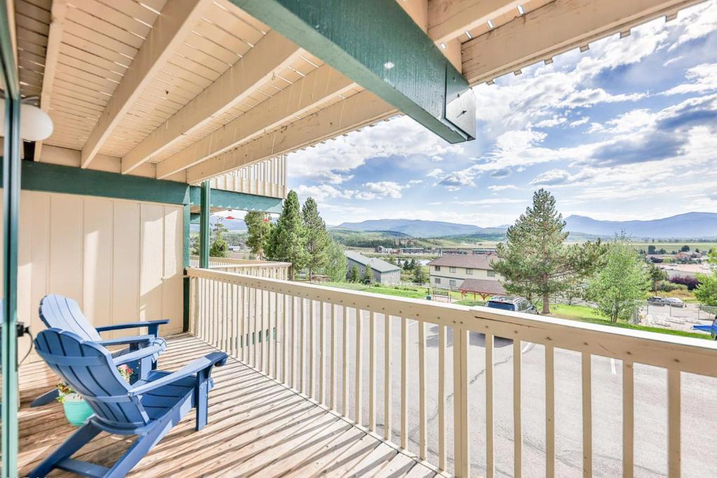 a blue rocking chair sitting on a balcony with a view at Winter Park Lodge II #104 in Fraser