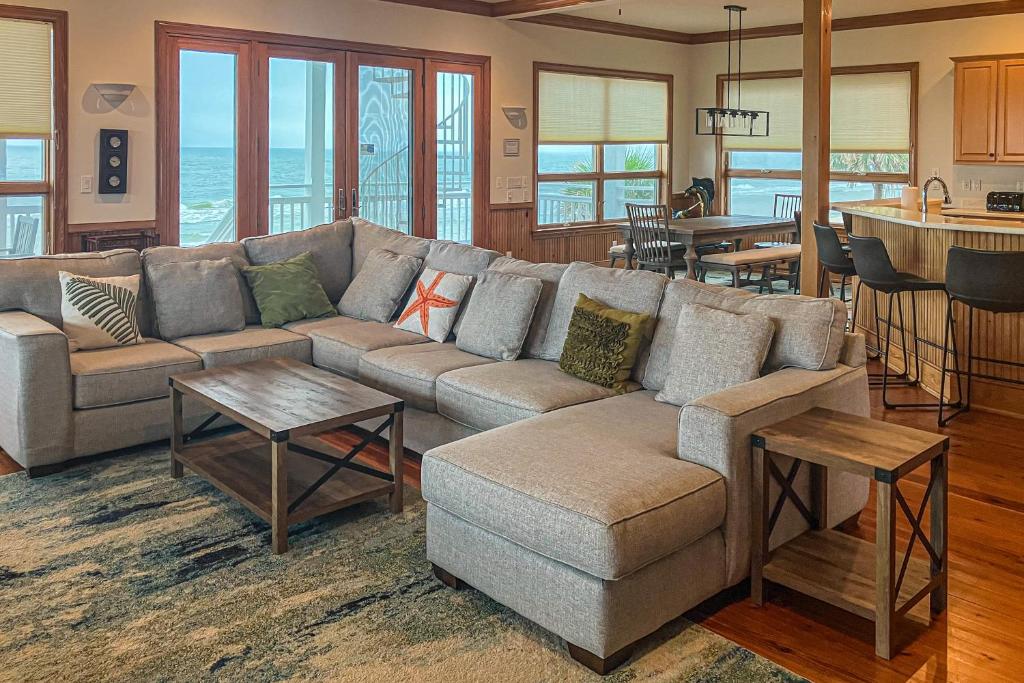a living room with a couch and a kitchen at Hello Sunshine in St. George Island