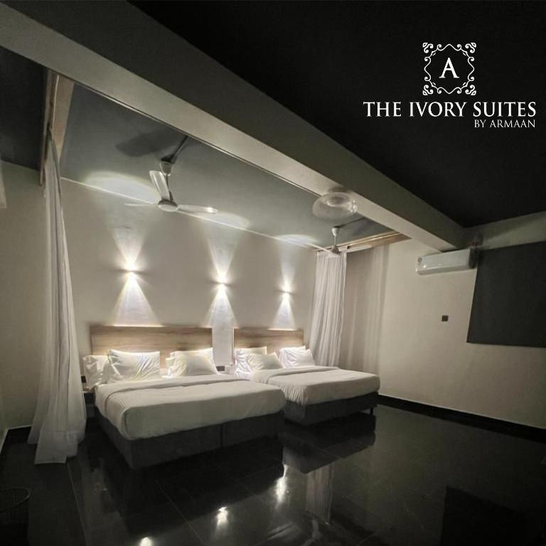 Postel nebo postele na pokoji v ubytování The Ivory Suites