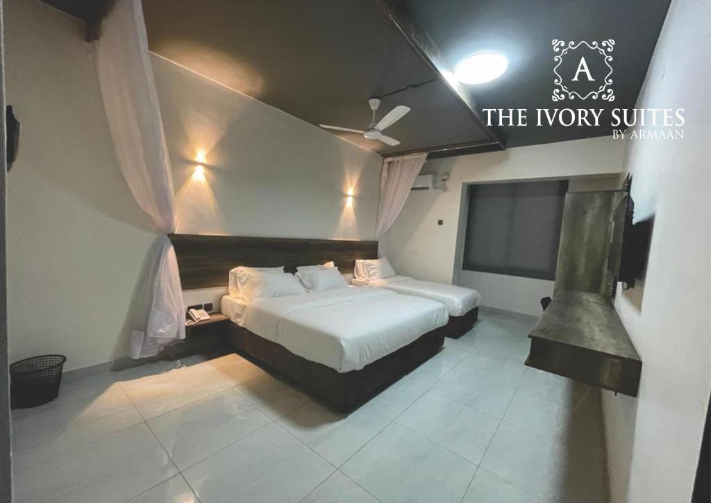 Postel nebo postele na pokoji v ubytování The Ivory Suites