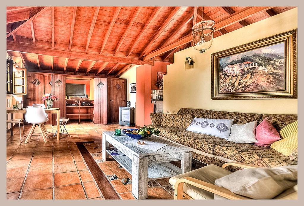 a living room with a couch and a table at Finca Cebollino in La Orotava