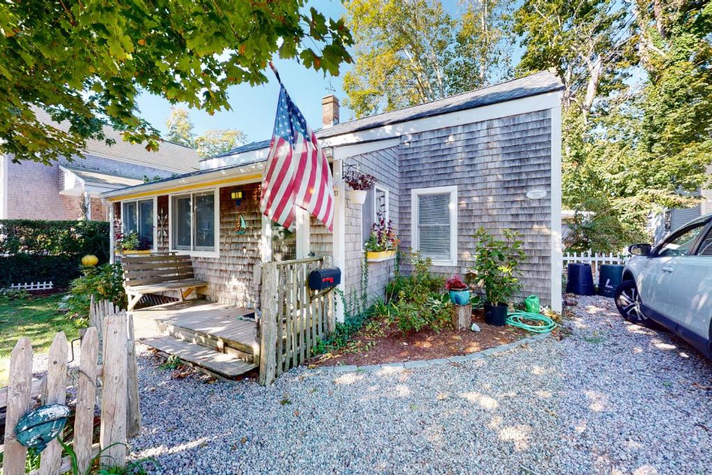 a small house with an american flag on it at Cape Cod-age in Falmouth