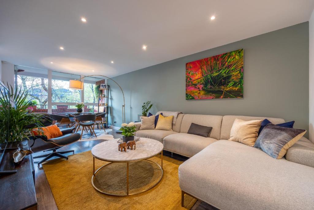 a living room with a couch and a table at Nino Homes Kings cross in London