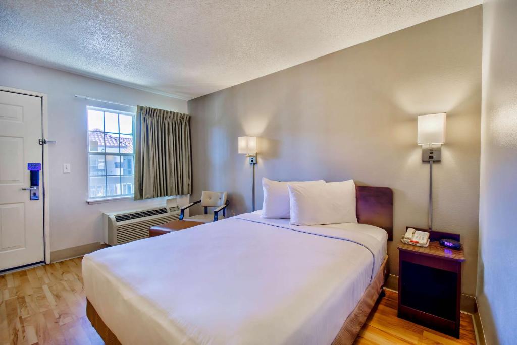 a hotel room with a large bed and a window at Studio 6-Phoenix, AZ - Deer Valley in Phoenix