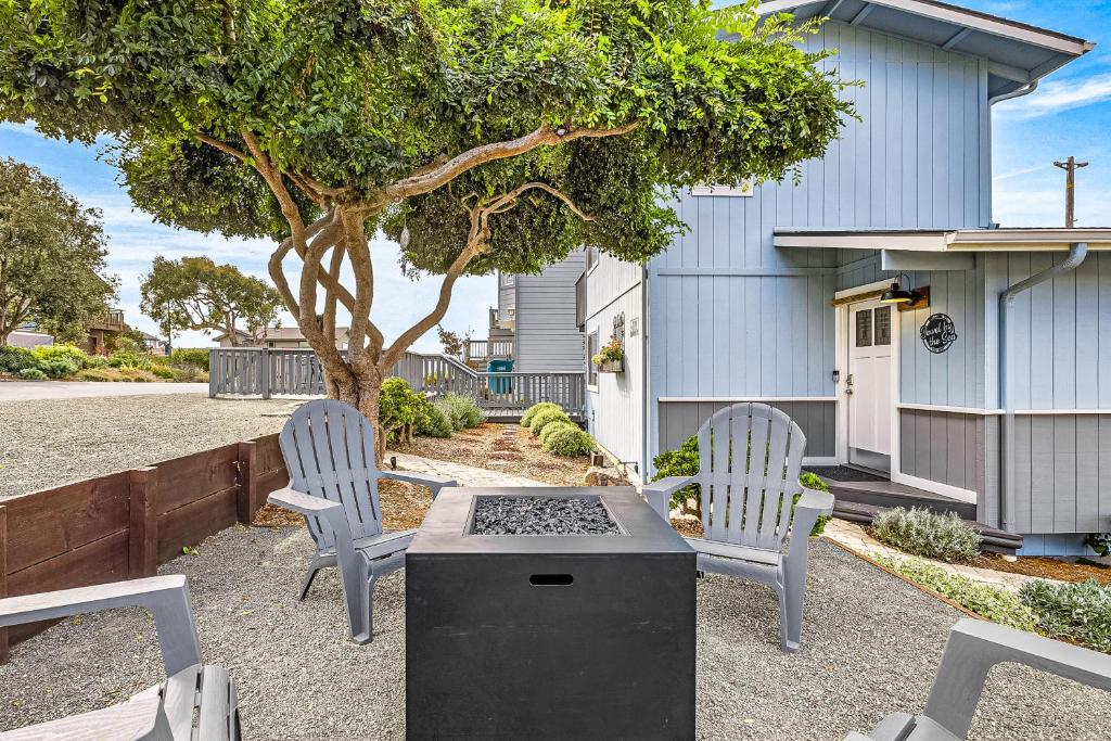 two chairs and a grill in front of a house at Jewel by the Sea in Cambria