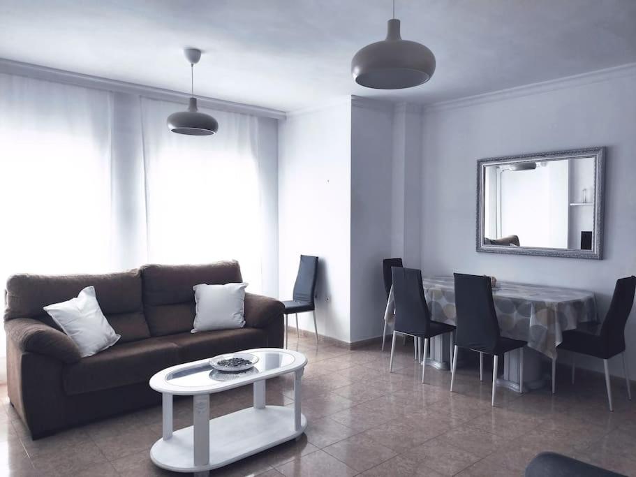 a living room with a couch and a table at Apartamento Las Brisas in Rincón de la Victoria