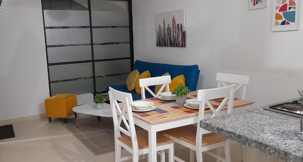 a dining room with a white table and chairs at La Tebaida Quindío Reserva de la Colina E104 in La Tebaida