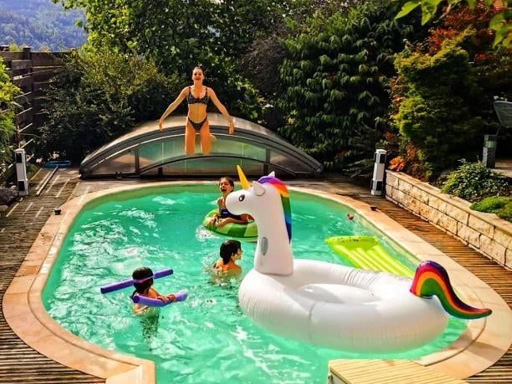 a woman standing on top of a pool with a unicorn at Gîte Rupt-sur-Moselle, 4 pièces, 6 personnes - FR-1-589-387 in Rupt-sur-Moselle